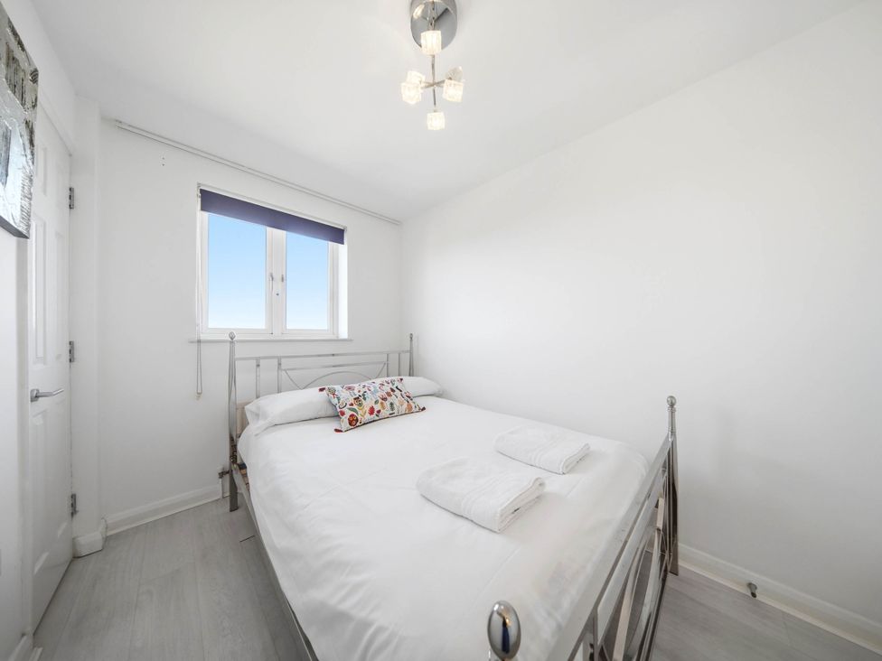 A bedroom with a bed and towels at 63 Vista Heights in Solihull