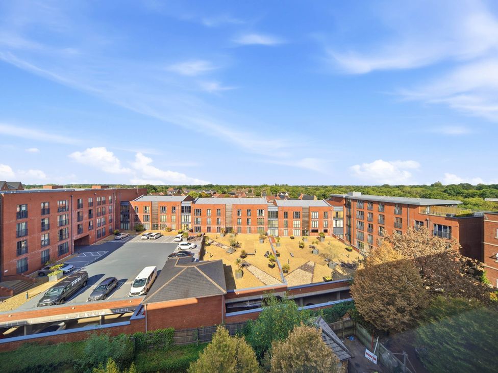 An outdoor view of an apartment building with parking and landscaped area at 63 Vista Heights in Solihull
