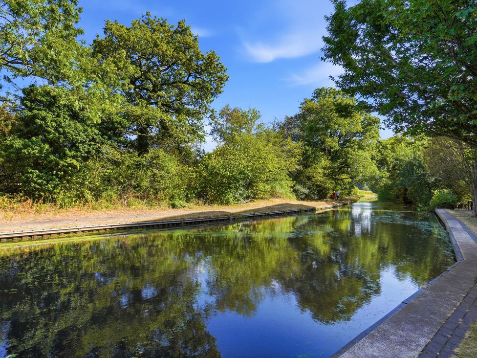 A canal with trees and a path at 63 Vista Heights in Solihull