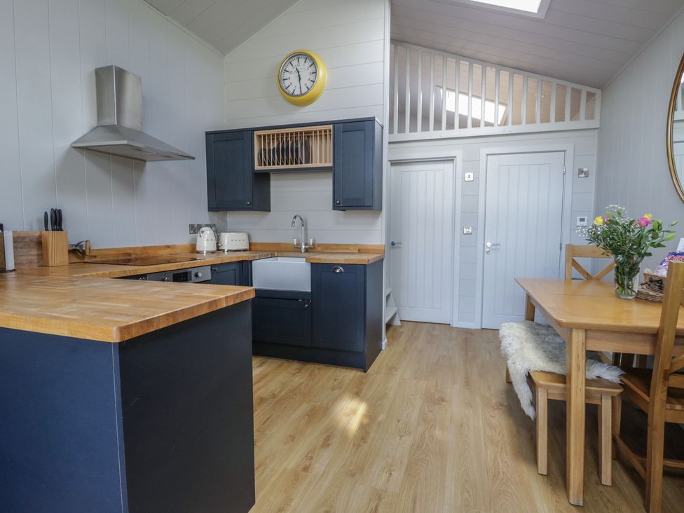 A kitchen with a dining area at Doe Lodge in Nantmel near Rhayader