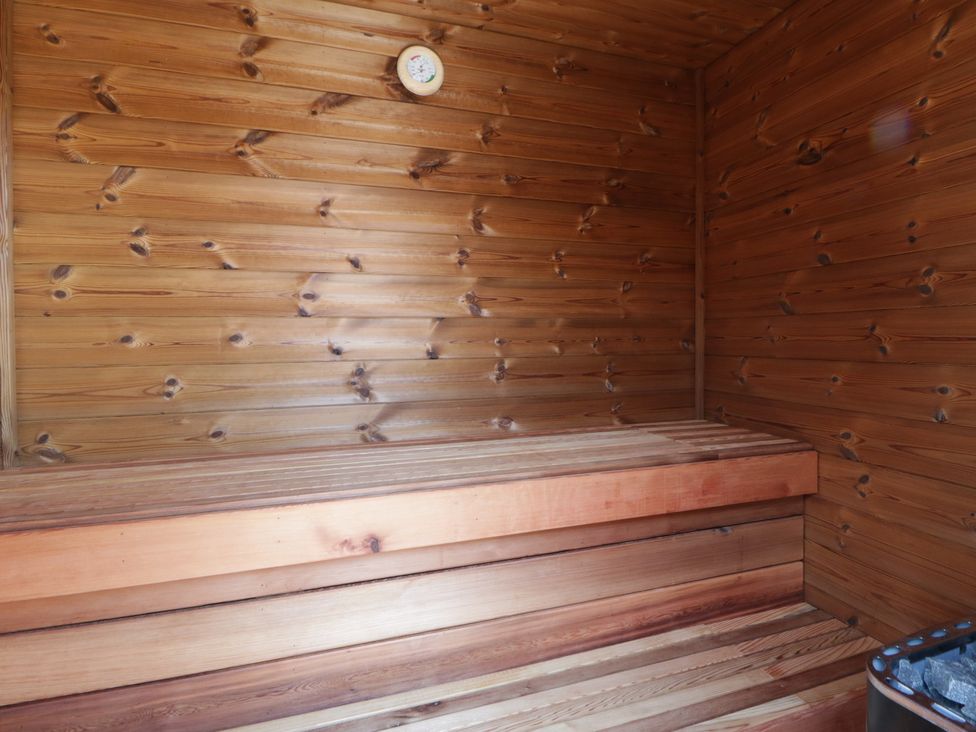 A sauna with wooden benches and walls at Tin Shed Nantmel near Rhayader