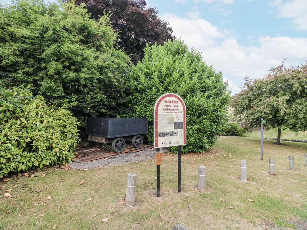 A sign and a railway cart in a park at Clematis Cottage in Fritchley near Crich