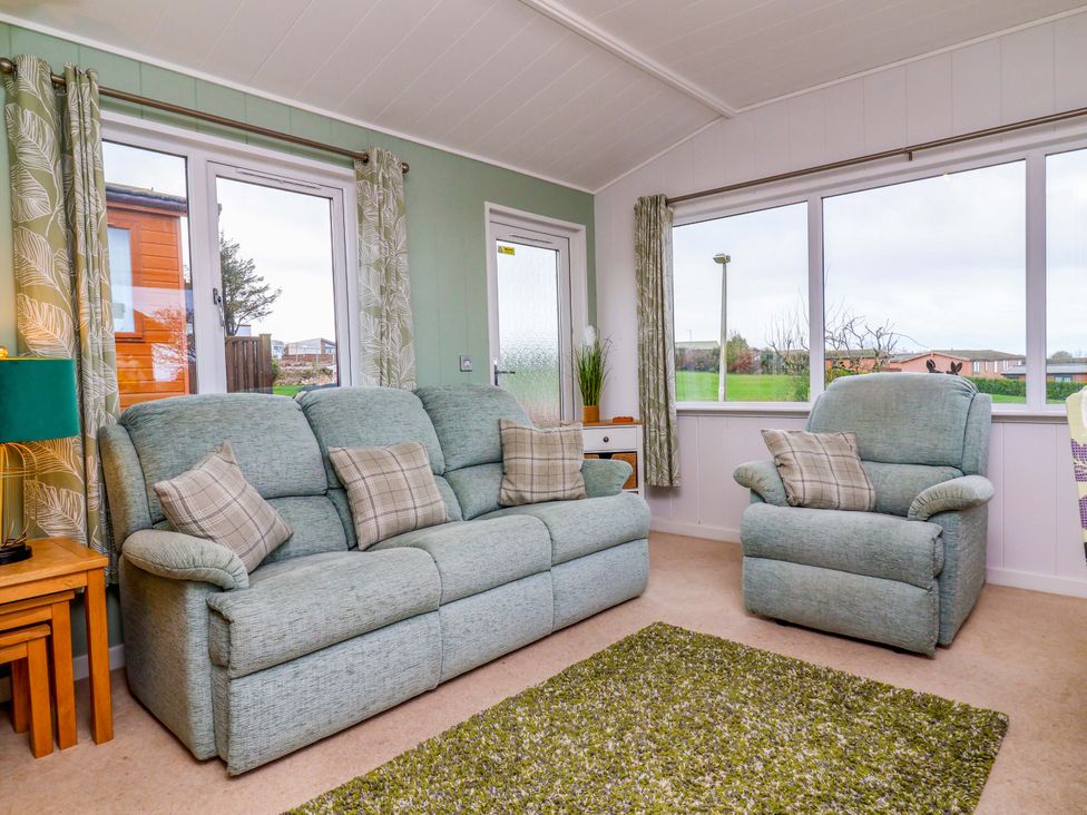 A snug with sofa and armchairs at Daffodil Lodge Mullacott near Ilfracombe