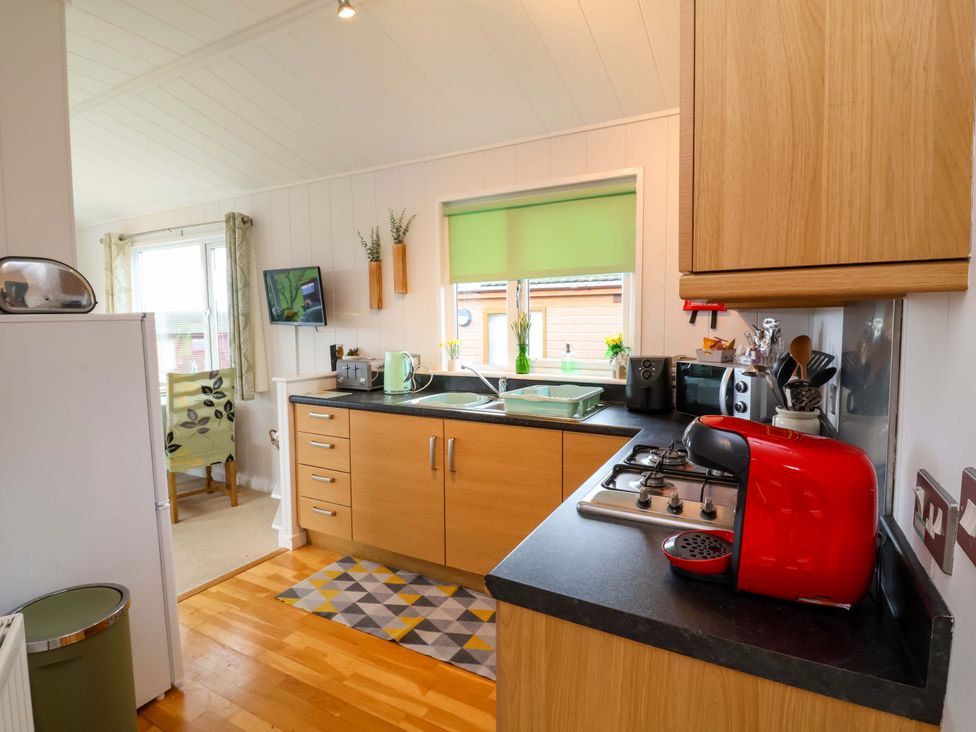 A kitchen with a sink and stove at Daffodil Lodge in Mullacott near Ilfracombe