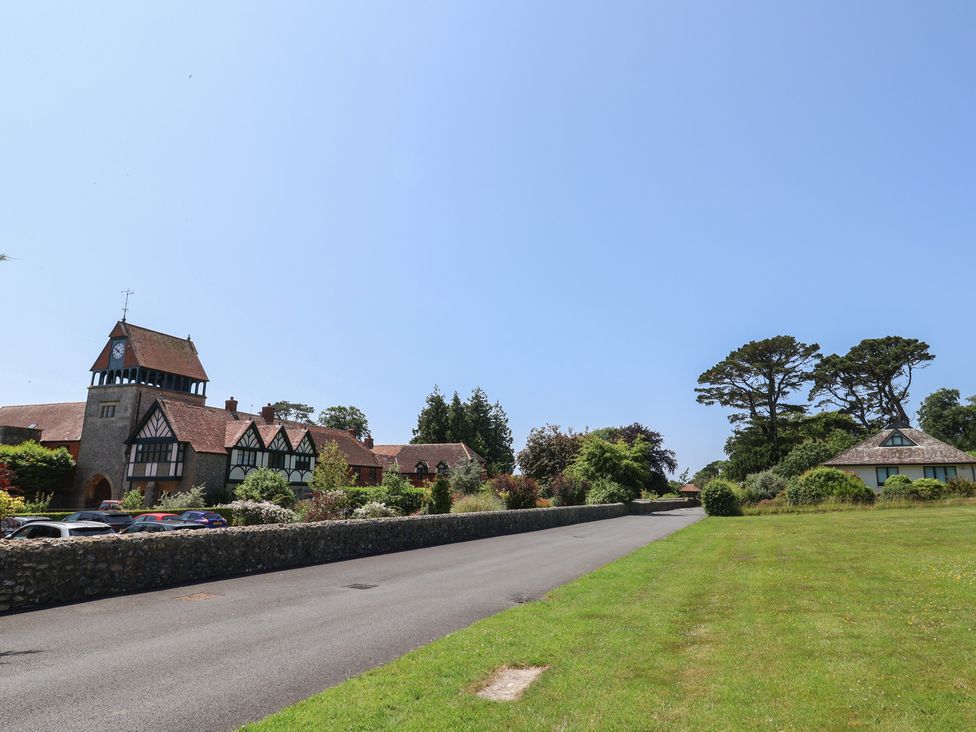 An outdoor area with a building and trees at 10 The Gardens in Rousdon near Lyme Regis