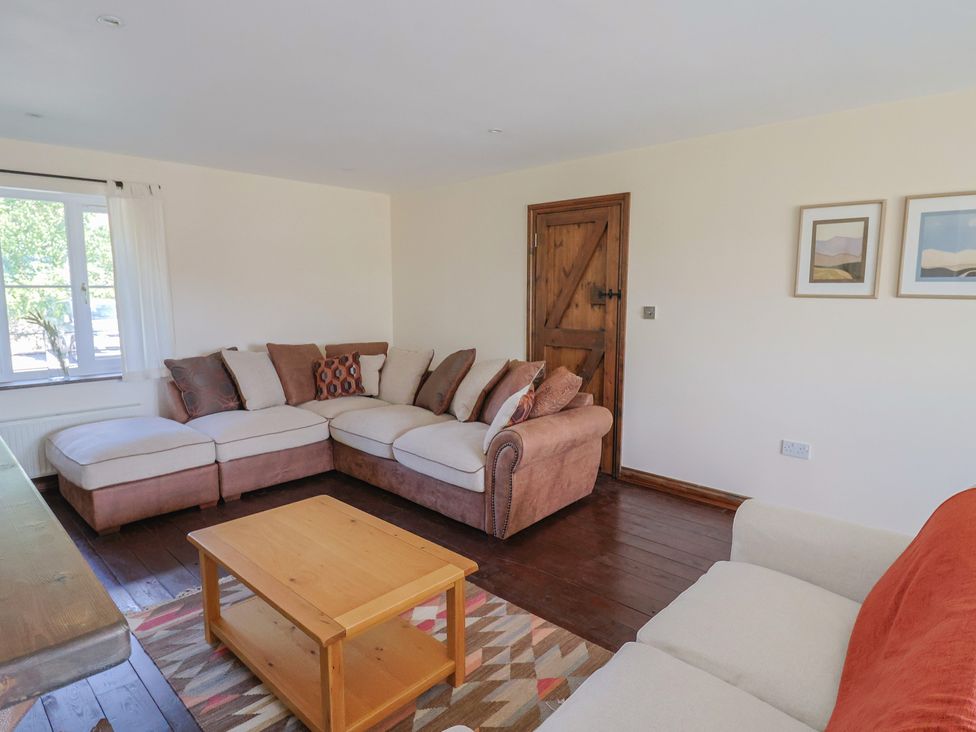 A living room with a sofa and coffee table at 10 The Gardens Rousdon near Lyme Regis