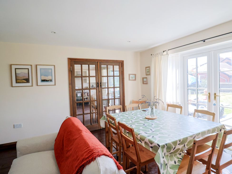 A dining room with a table and chairs at 10 The Gardens Rousdon near Lyme Regis