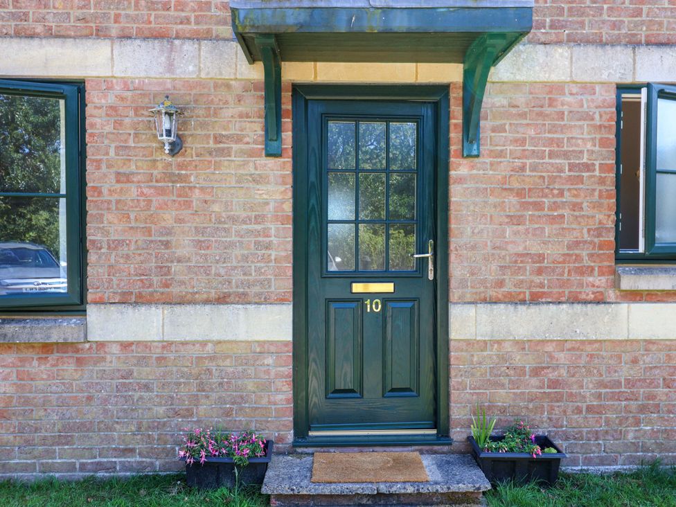 A front door with number 10 and a light fixture at 10 The Gardens Rousdon near Lyme Regis