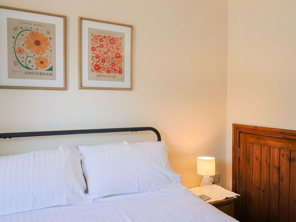 A bedroom with a bed and wall art at 10 The Gardens Rousdon near Lyme Regis
