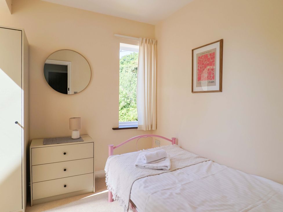 A bedroom with a bed and nightstand at 10 The Gardens Rousdon near Lyme Regis