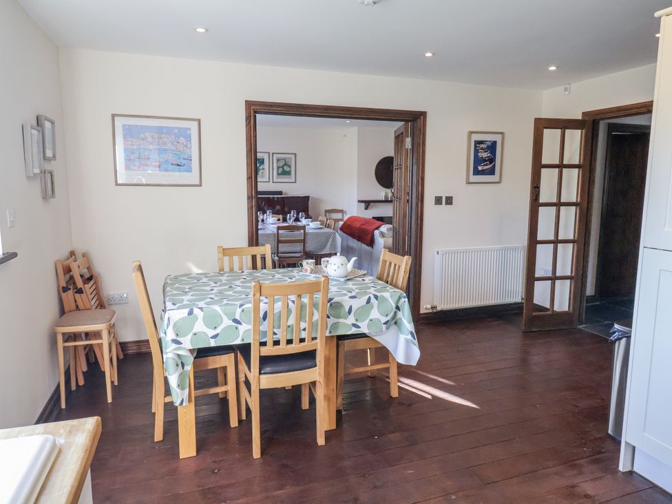 A dining room with a table and chairs at 10 The Gardens in Rousdon near Lyme Regis