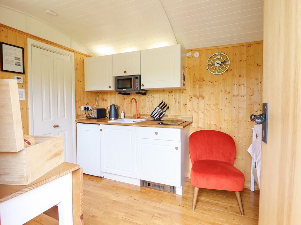 A kitchen with a microwave and sink at Red Kite at Wild Valley Huts Llanrhaeadr-Ym-Mochnant