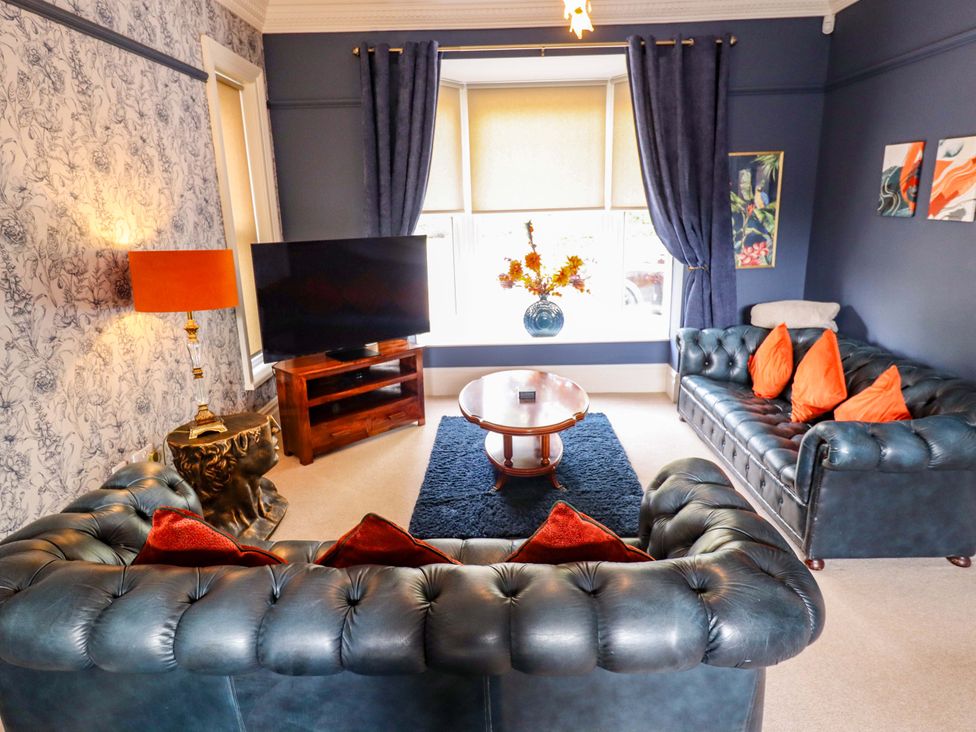 A living room with a television and sofas at 105 Spilsby Road in Boston
