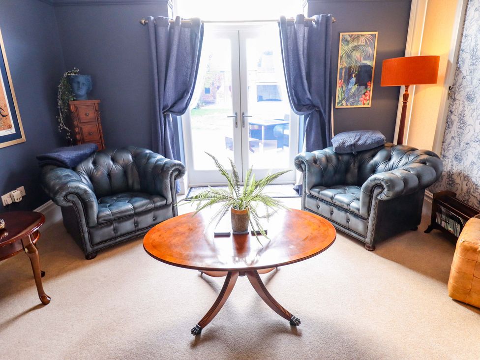 A living room with two sofas and a table at 105 Spilsby Road in Boston