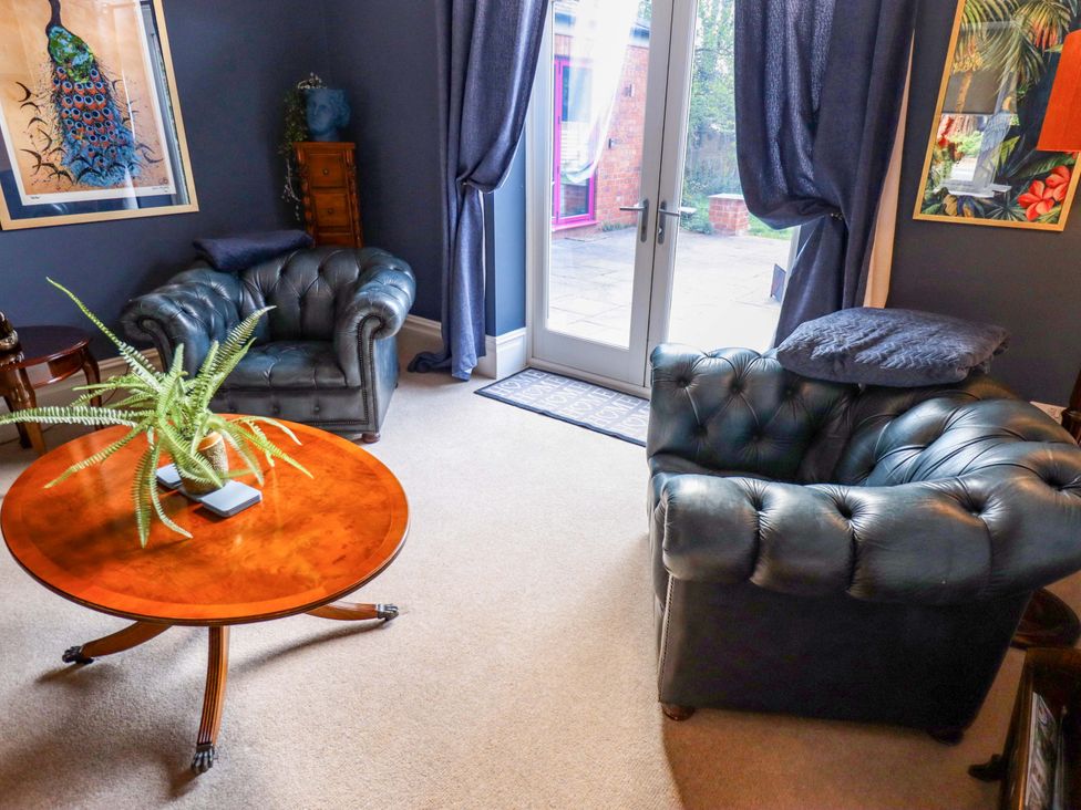 A living room with armchairs and a table at 105 Spilsby Road in Boston