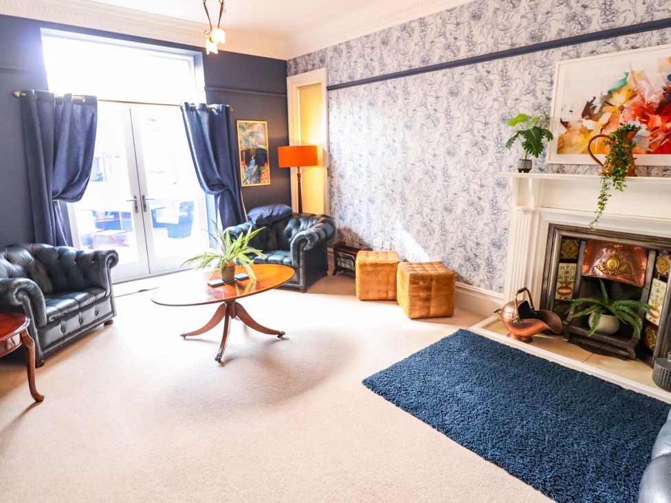 A living room with a table and sofas at 105 Spilsby Road in Boston