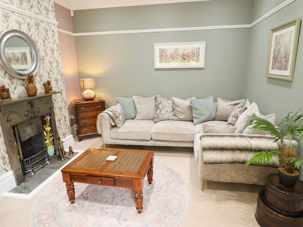 A living room with a sofa and coffee table at 105 Spilsby Road in Boston