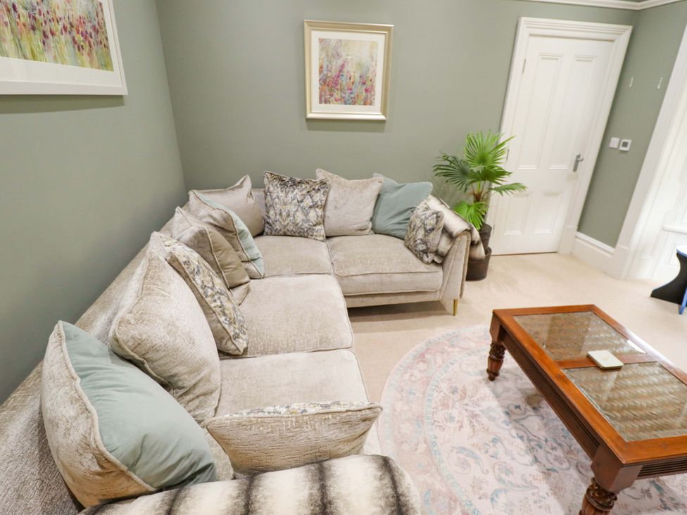 A living room with a sectional sofa and coffee table at 105 Spilsby Road in Boston