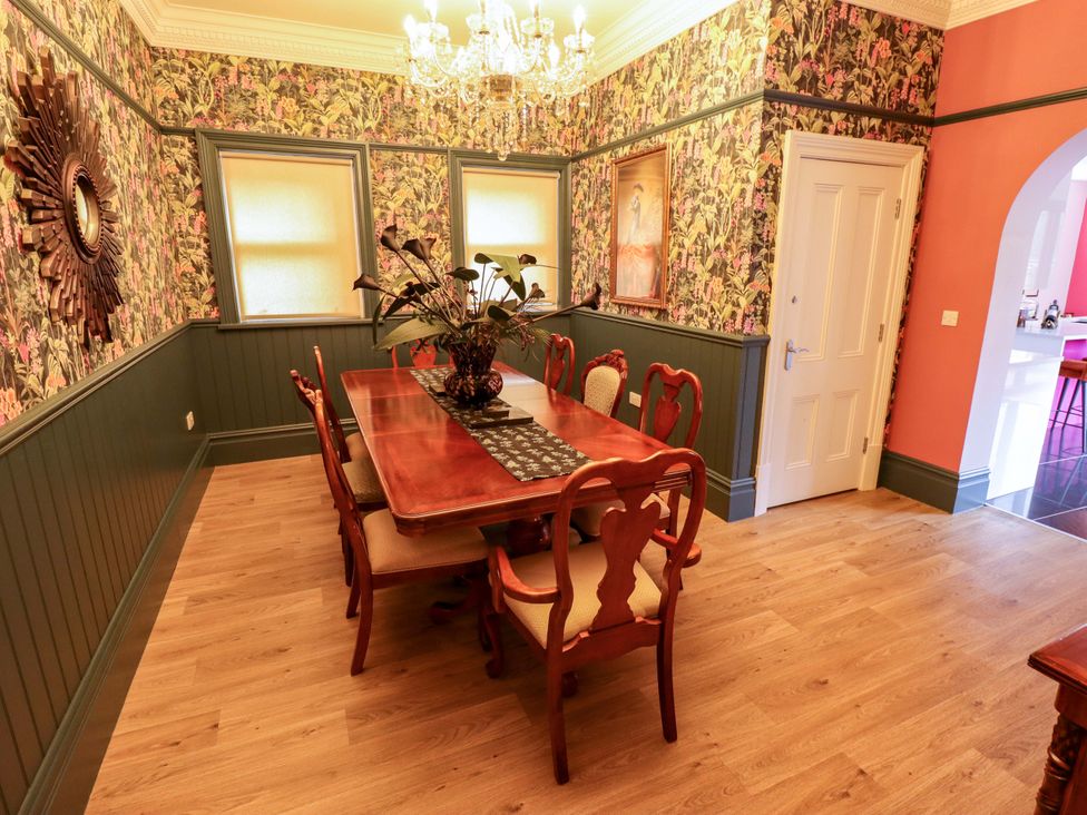 A dining room with a table and chairs at 105 Spilsby Road in Boston