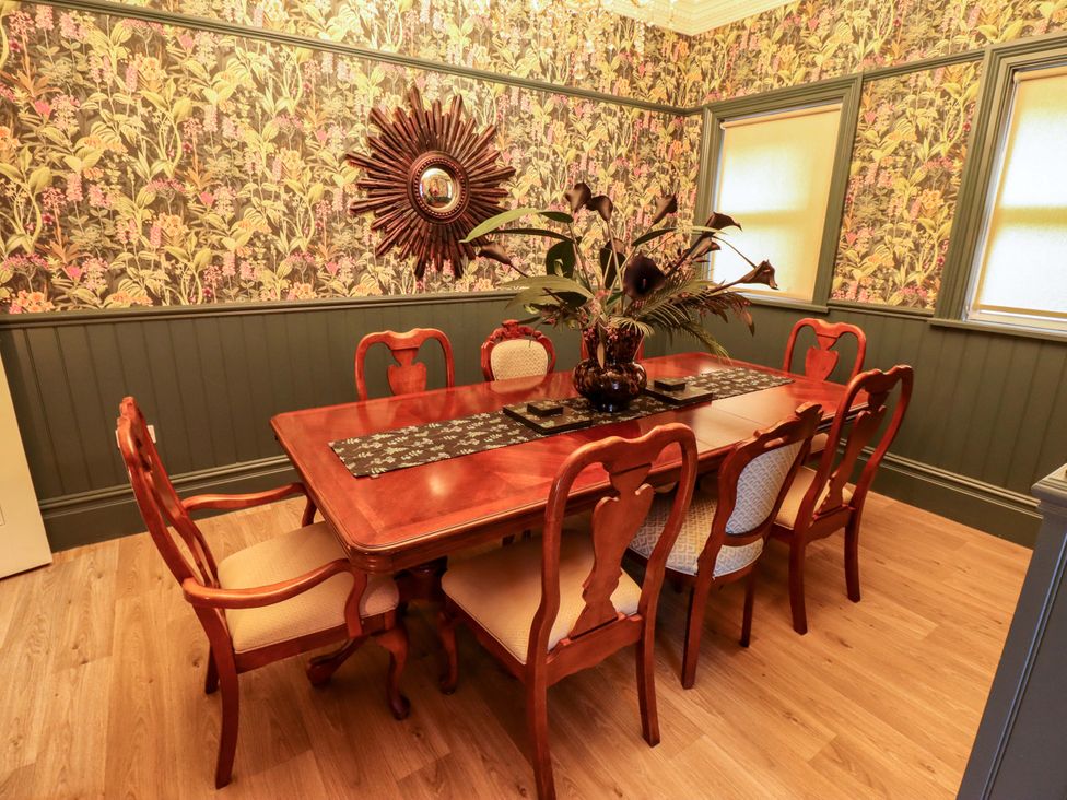 A dining room with a wooden table and chairs at 105 Spilsby Road Boston