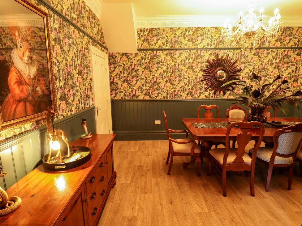 A dining room with a table and chairs at 105 Spilsby Road in Boston