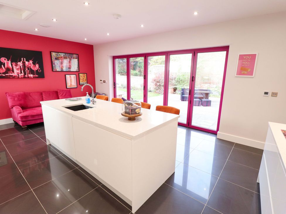 A kitchen with a white island and pink accents at 105 Spilsby Road in Boston