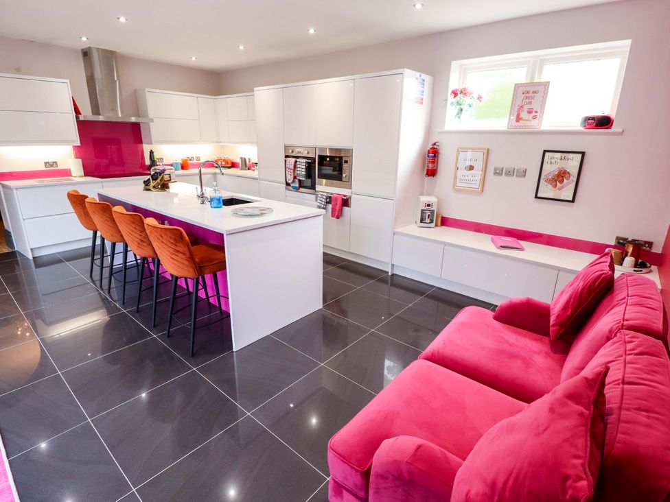 A kitchen with modern appliances and seating at 105 Spilsby Road in Boston