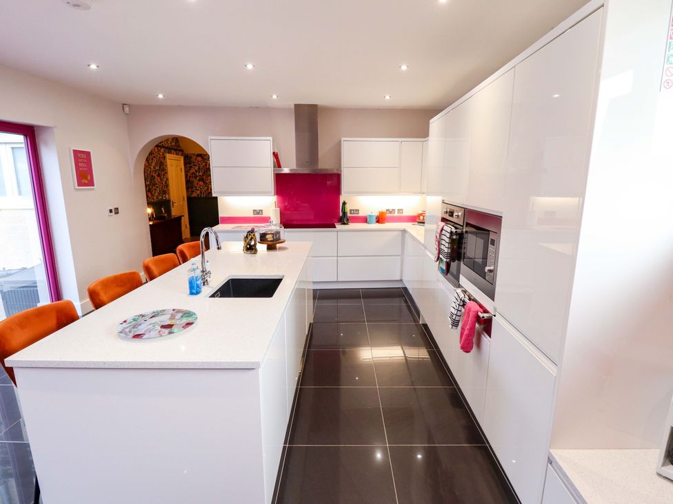 A kitchen with a sink and modern appliances at 105 Spilsby Road in Boston