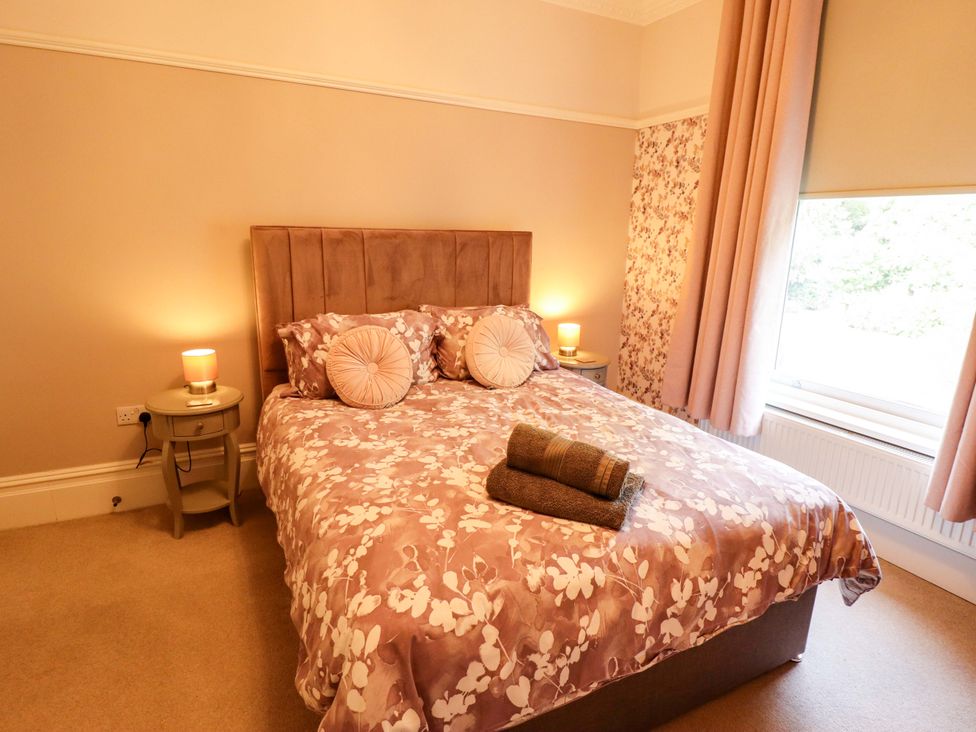 A bedroom with a bed, bedside table, and window at 105 Spilsby Road Boston