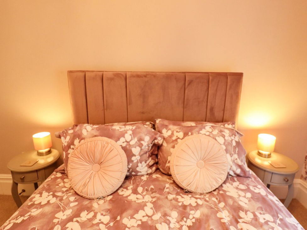 A bed with pillows and bedside tables at 105 Spilsby Road in Boston