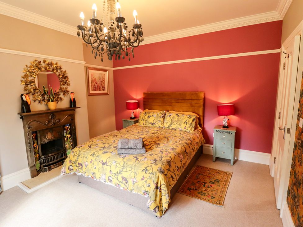 A bedroom with a bed and lamps at 105 Spilsby Road in Boston