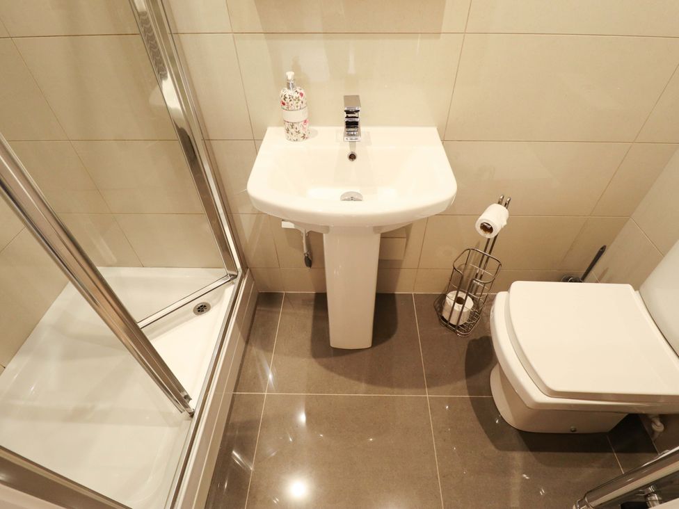 A bathroom with a shower, sink, and toilet at 105 Spilsby Road, Boston