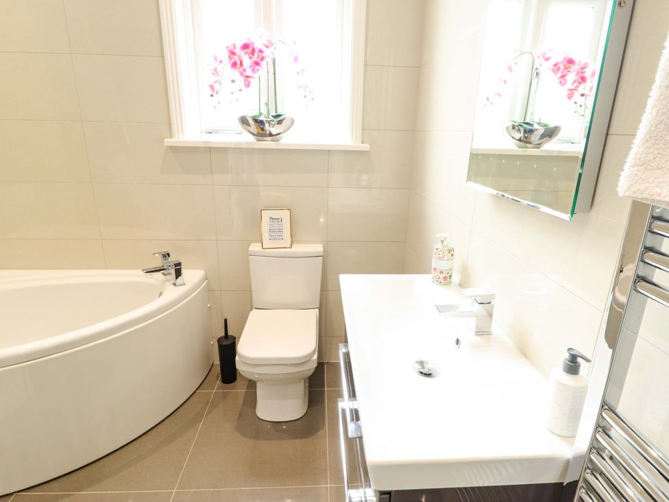 A bathroom with a bathtub, toilet, and sink at 105 Spilsby Road in Boston