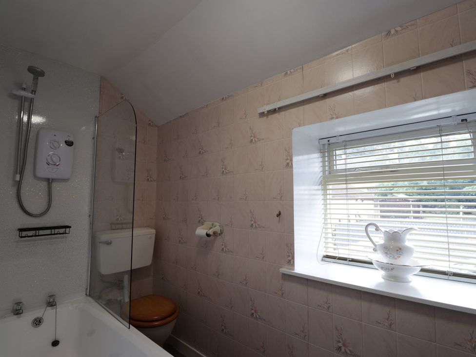 A bathroom with a shower and bathtub at Ivy House in Kingussie