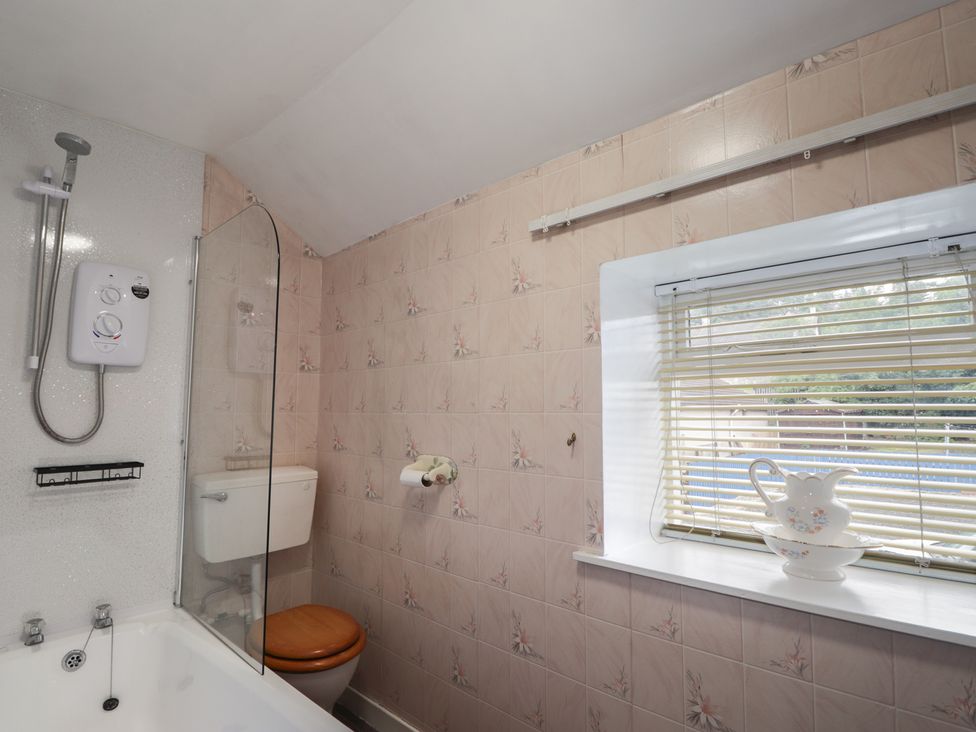 A bathroom with a shower and a bathtub at Ivy House in Kingussie