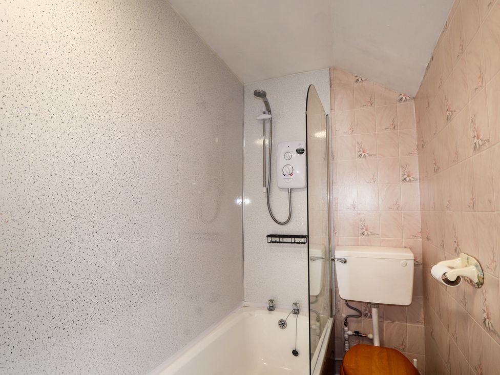 A bathroom with a shower and bathtub at Ivy House in Kingussie
