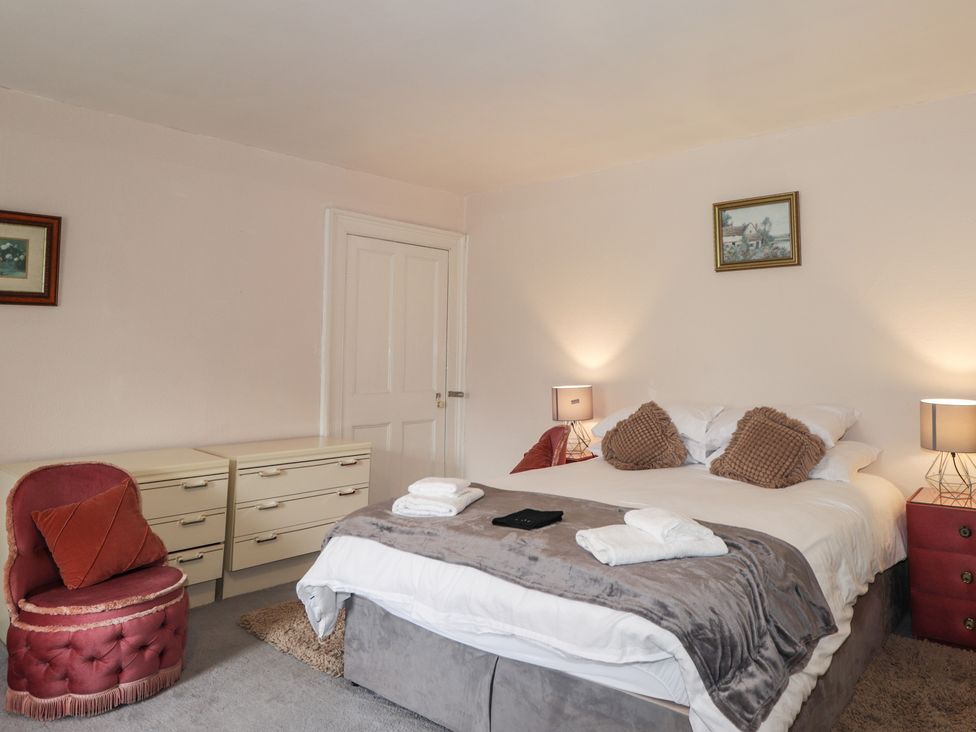 A bedroom with a bed and dresser at Ivy House in Kingussie