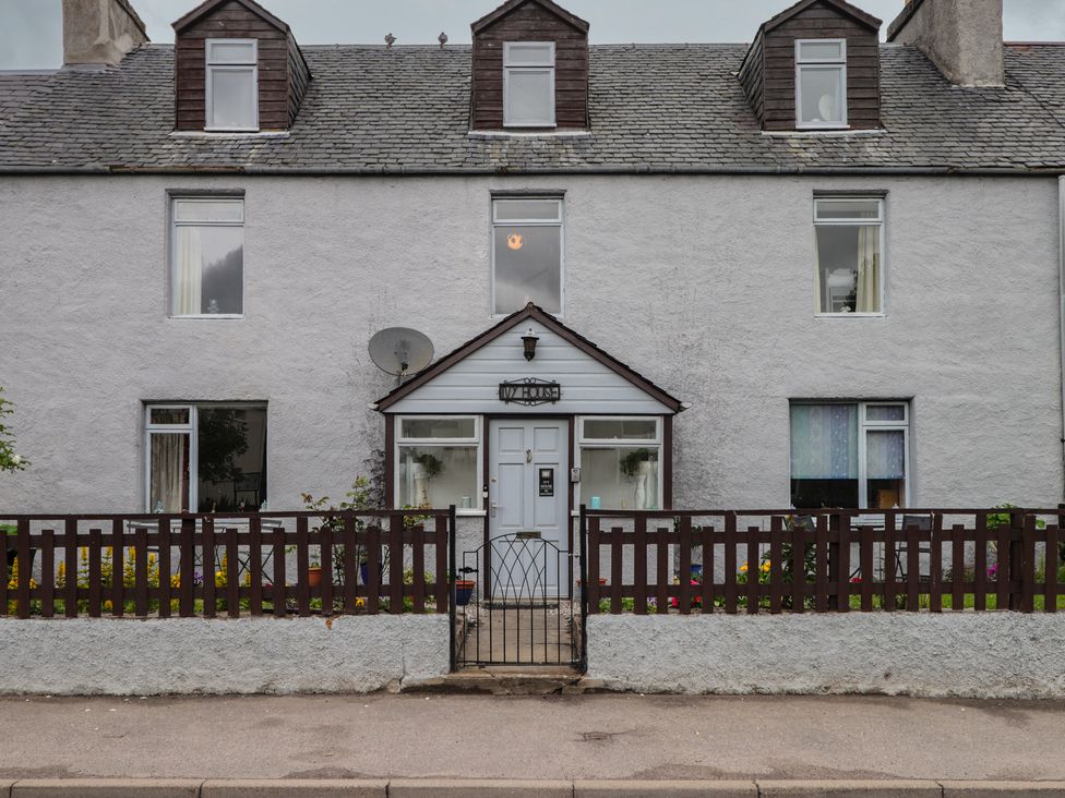 A house with a fence and garden at Ivy House in Kingussie