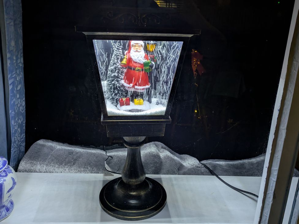 A lantern with a Santa figure inside at Ivy House in Kingussie