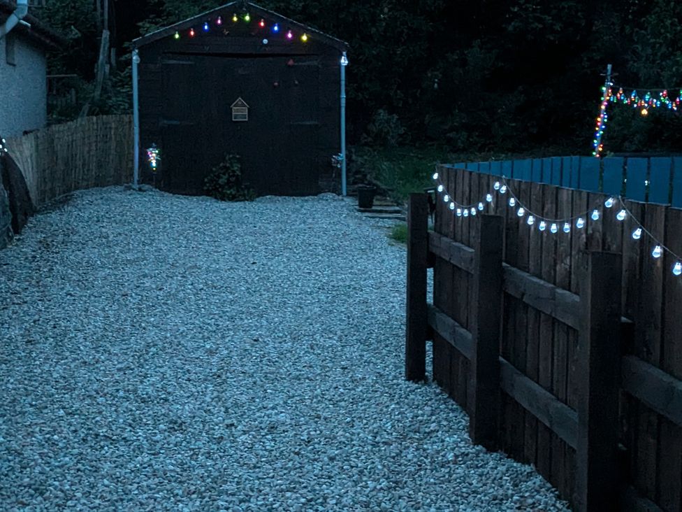 An outdoor area with a gravel path and a shed at Ivy House in Kingussie