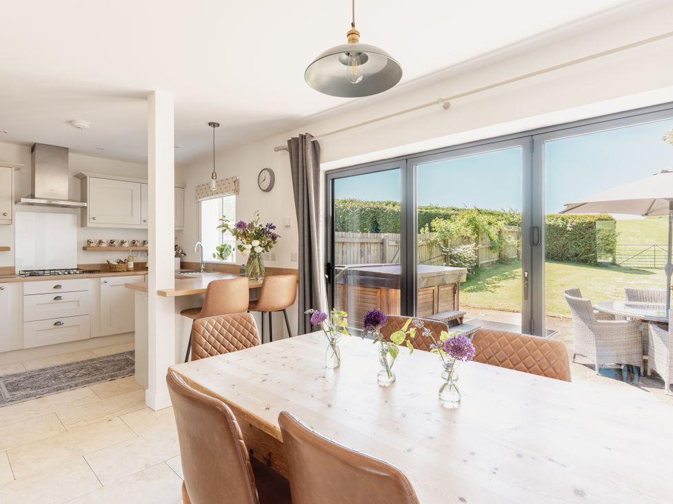 A kitchen with a table and chairs at Tokenhill Cottage Piddletrenthide