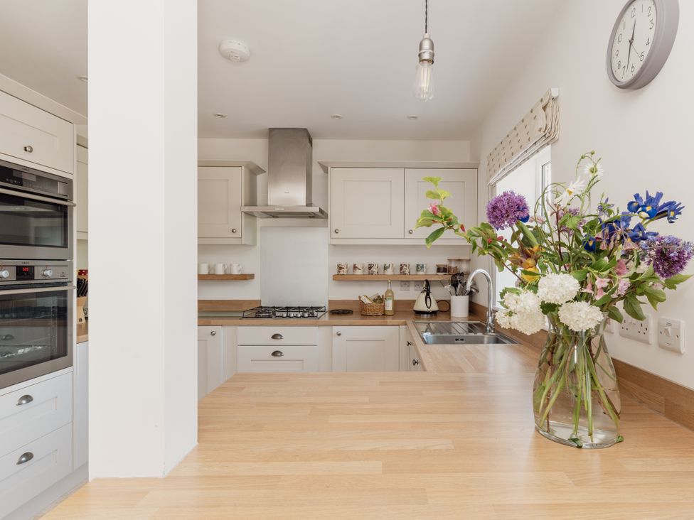 A kitchen with countertops and appliances at Tokenhill Cottage in Piddletrenthide
