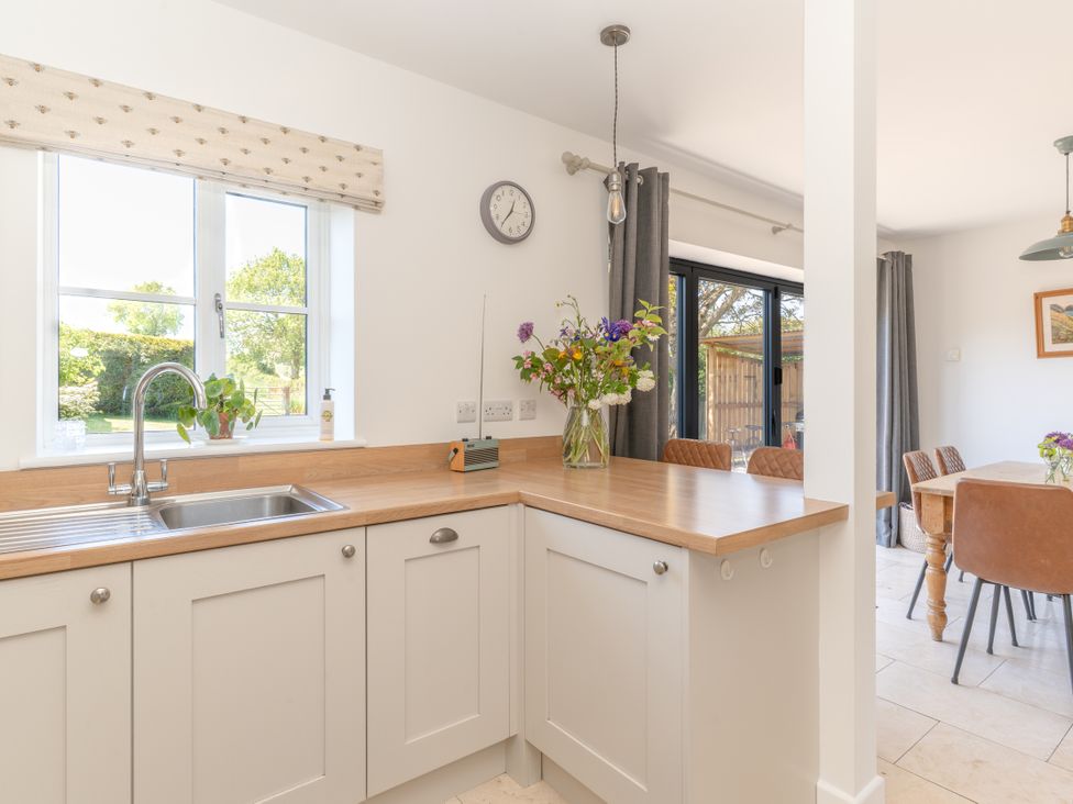 A kitchen with a sink and countertop at Tokenhill Cottage in Piddletrenthide