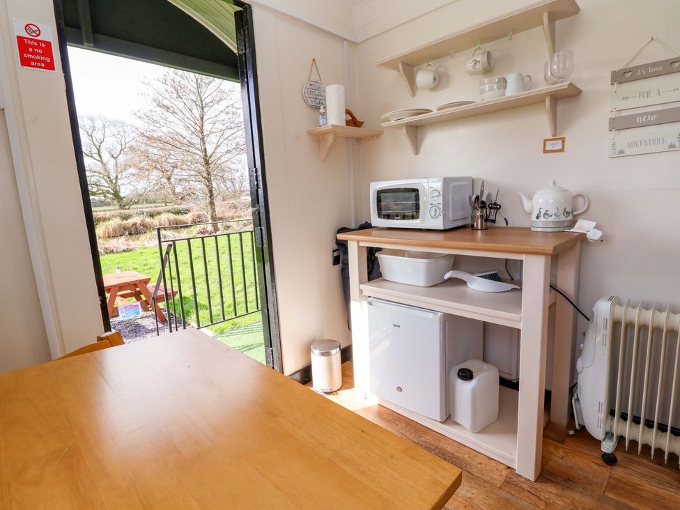 A kitchen with appliances and a door leading outside at Quackin' Up