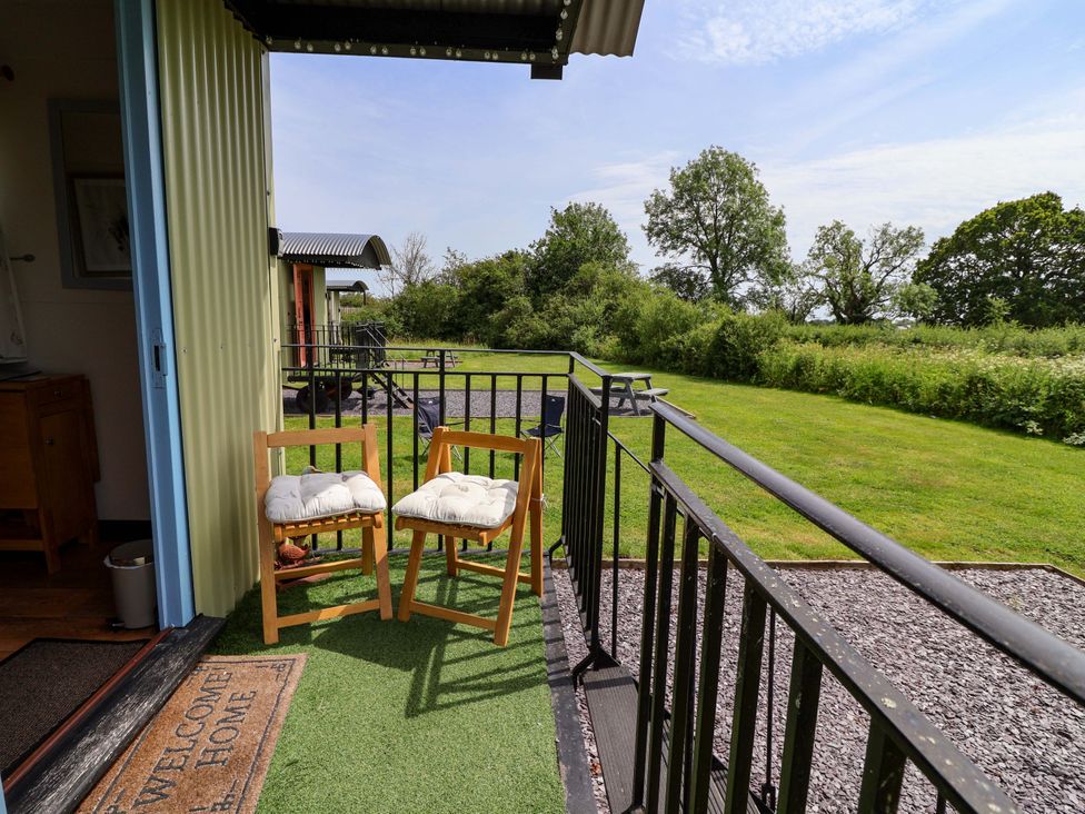 A balcony with chairs and a view of trees at Quackin' Up