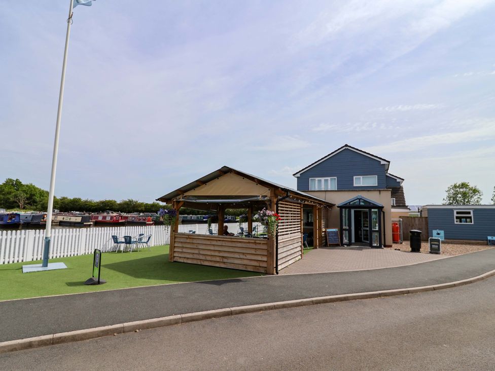 An outdoor area with a building and seating at Quackin' Up