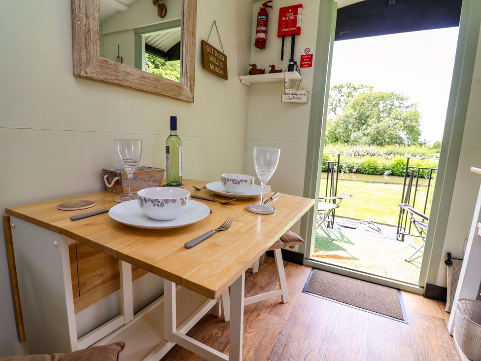 A dining area with a table set for two at Hop To It 