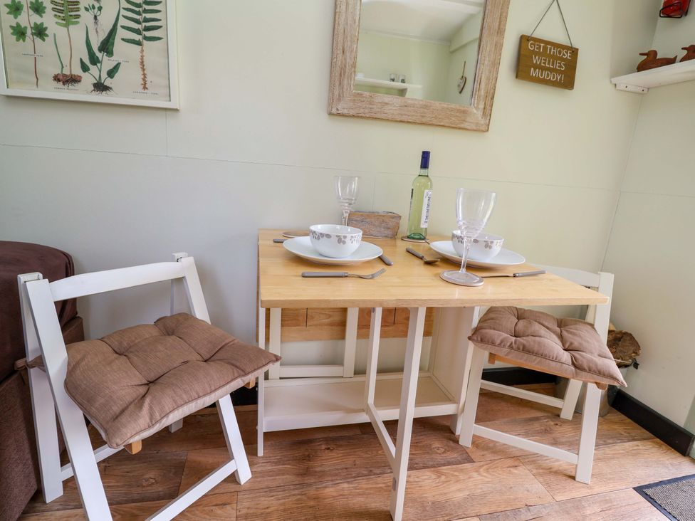 A dining table set with plates and glasses at Hop To It