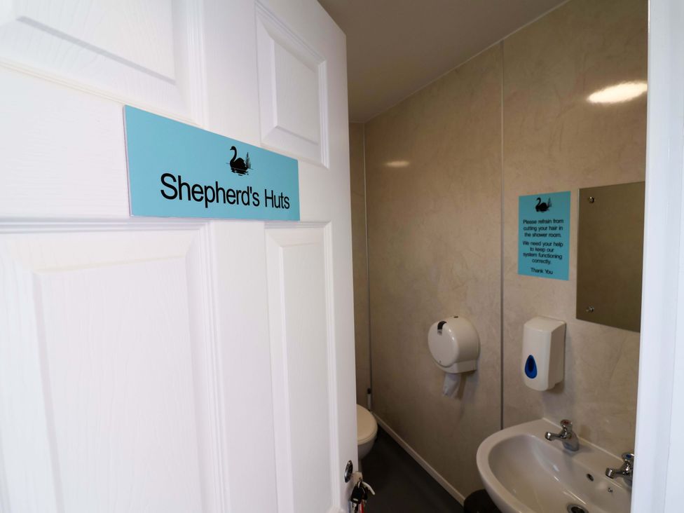 A bathroom with a toilet and sink at Hop To It
