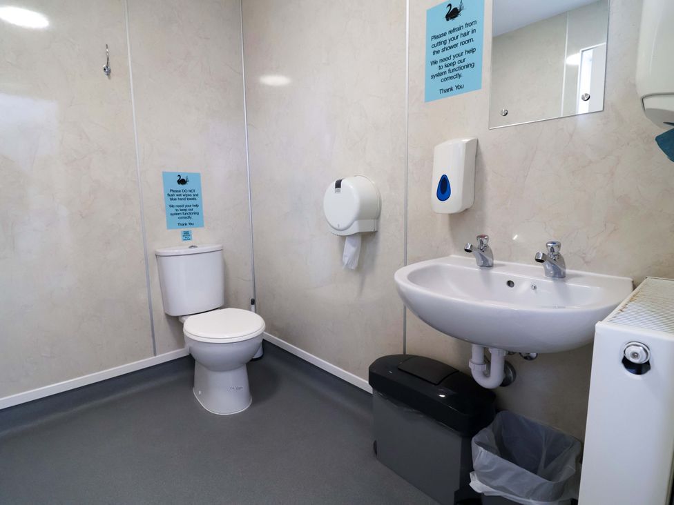 A bathroom with a toilet and sink at Hop To It